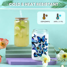 Glass jars with butterfly design and iced drink on a light blue background