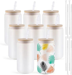 Set of white jars with bamboo lids and straws, one featuring a tropical leaf pattern.