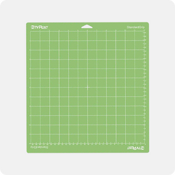 Green cutting mat with grid pattern on a white background