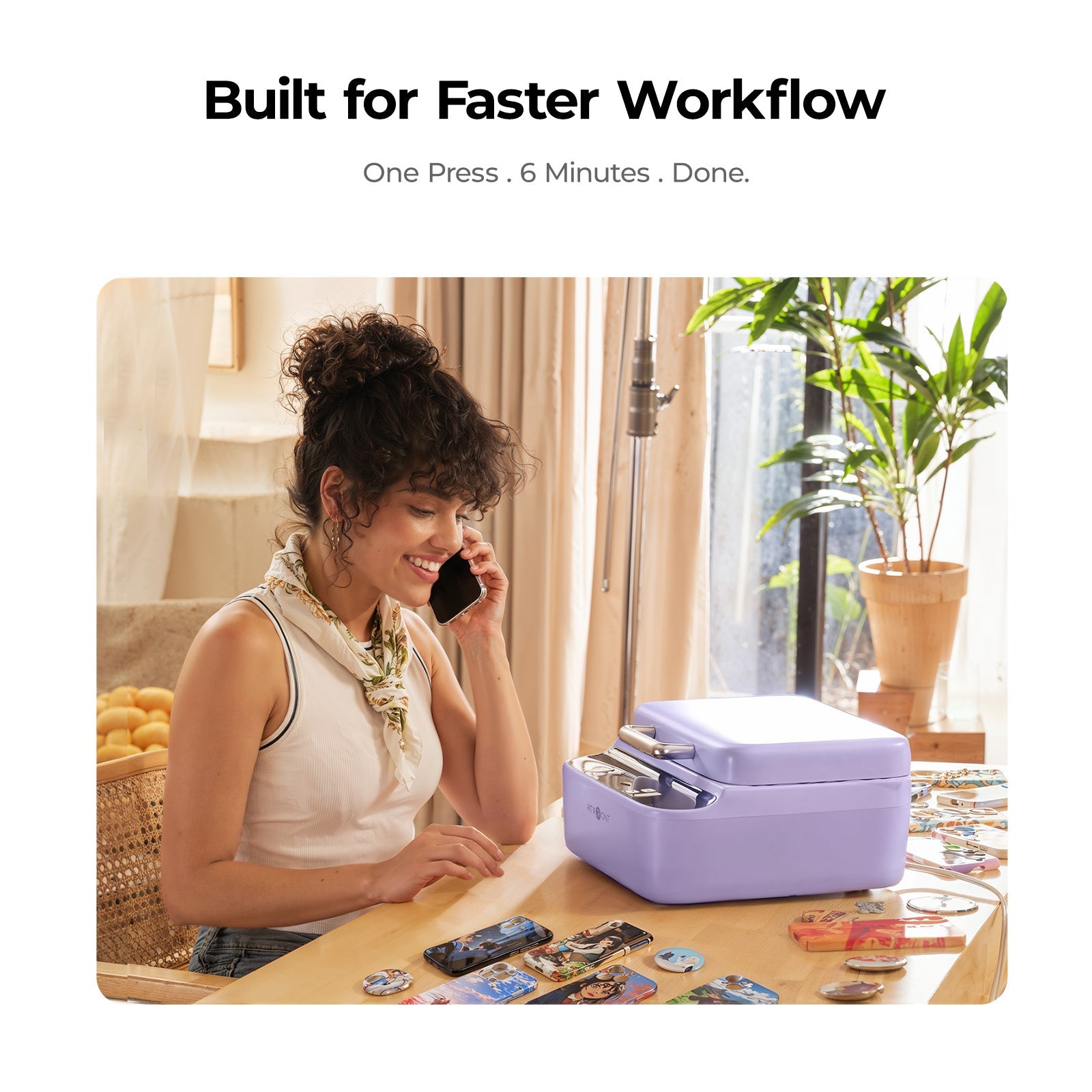 Woman on phone with a purple heat press on a desk, text 'Built for Faster Workflow'.