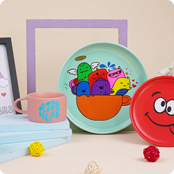 Colorful children's plates with cartoon designs on a light background