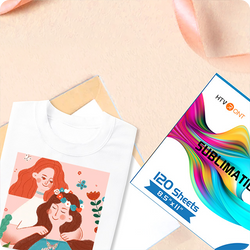 White t-shirt with a colorful graphic and a box of HTV Print Sublimation paper on a beige surface.